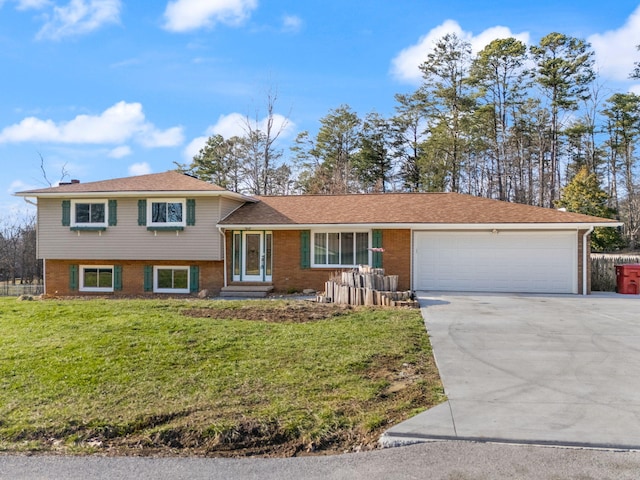 split level home with a garage, driveway, a front lawn, and brick siding