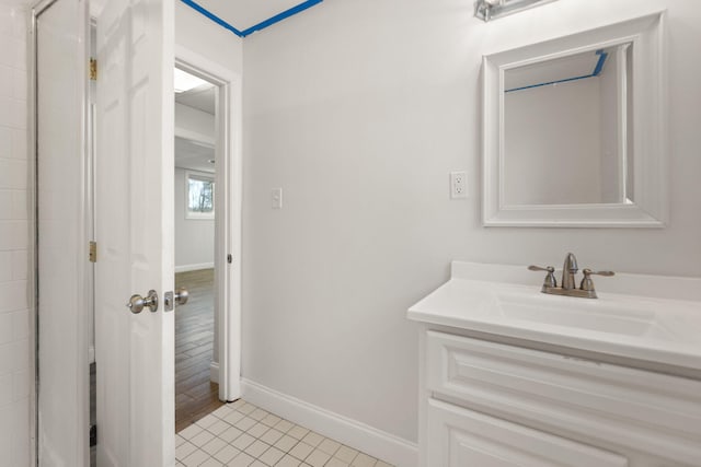 bathroom featuring tile patterned flooring, baseboards, and vanity