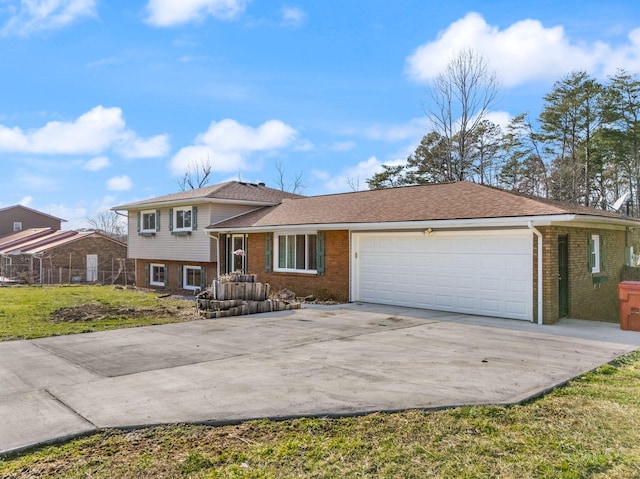 split level home with a front yard, brick siding, driveway, and an attached garage