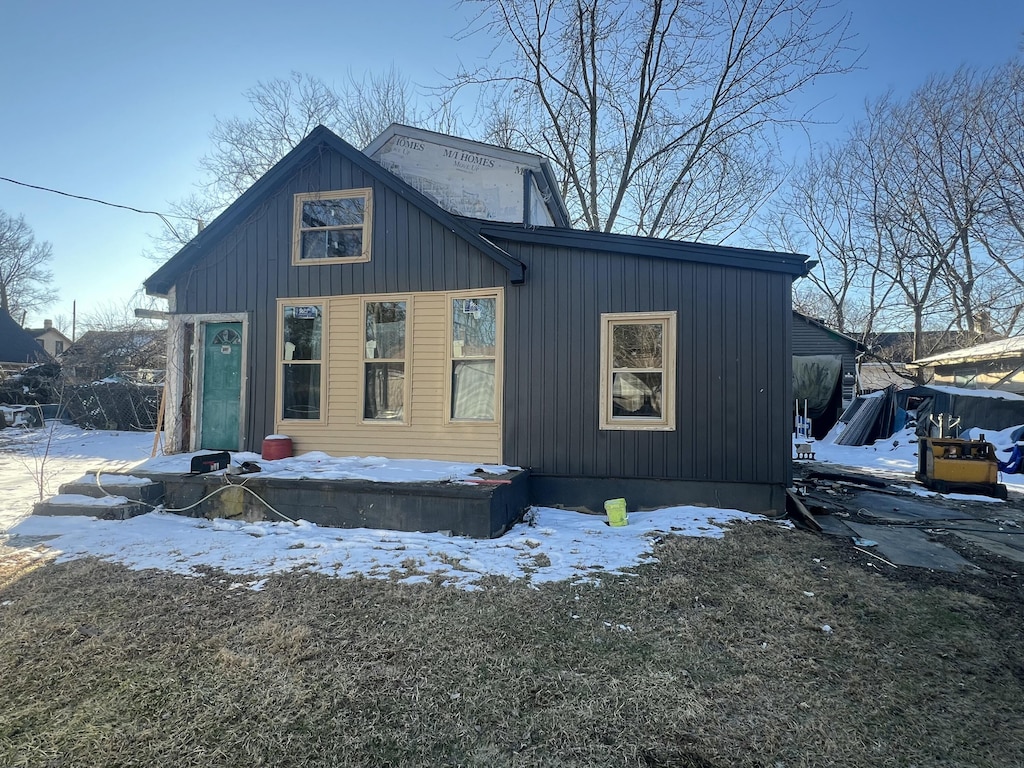 snow covered property featuring board and batten siding