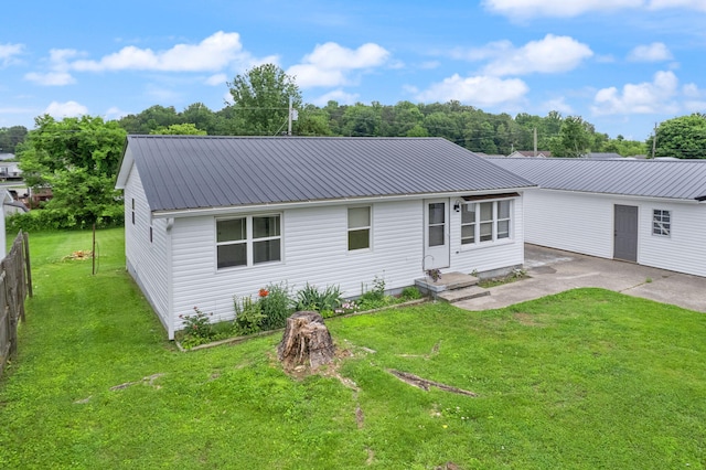 single story home with metal roof and a front yard