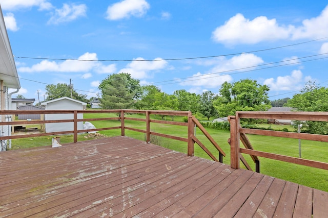 wooden deck featuring a yard