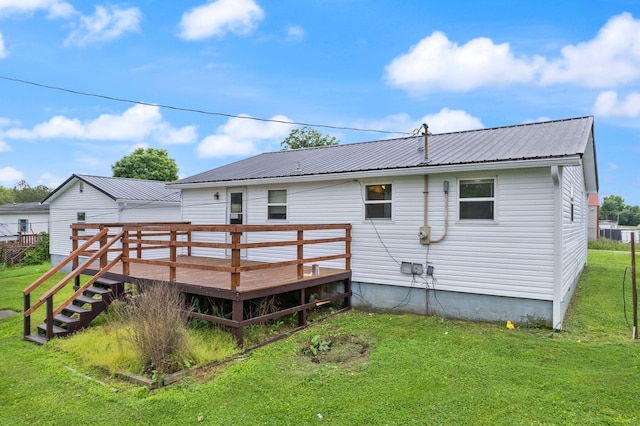 back of house with a deck, metal roof, stairway, and a lawn