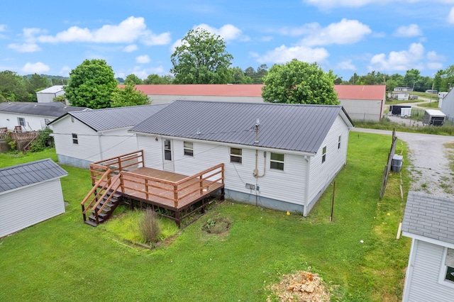 back of house with stairway, a yard, metal roof, and a deck