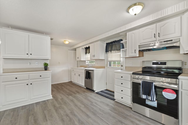 kitchen featuring stainless steel appliances, light countertops, white cabinets, and under cabinet range hood