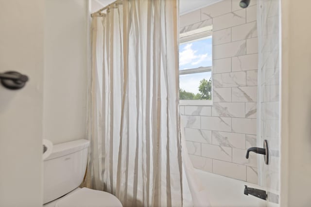 bathroom with toilet and a shower with curtain