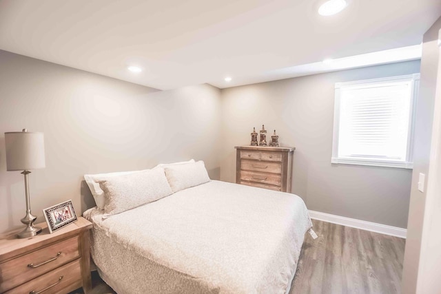 bedroom featuring recessed lighting, wood finished floors, and baseboards