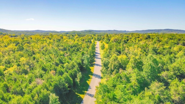 drone / aerial view featuring a view of trees