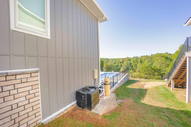 view of side of property with a yard and central AC unit