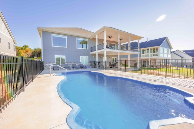 view of swimming pool with fence and a ceiling fan