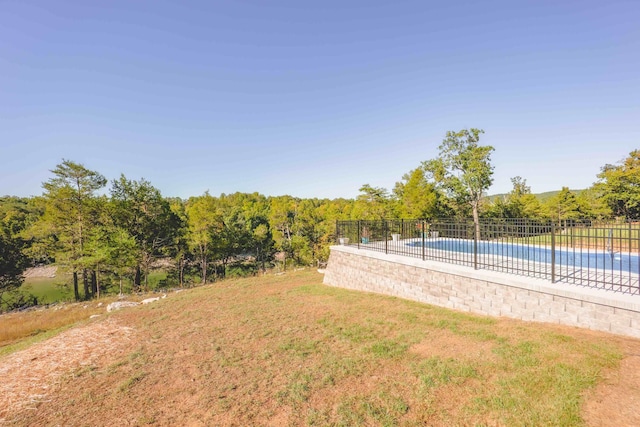 view of yard featuring fence and a fenced in pool