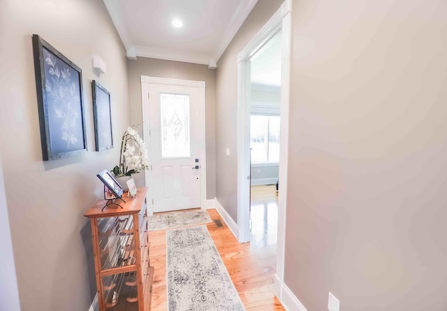 entryway with baseboards, wood finished floors, and crown molding