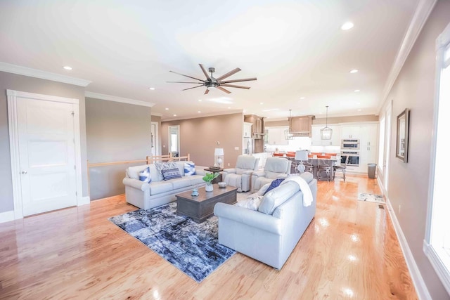 living area featuring light wood-style floors, recessed lighting, ornamental molding, and baseboards