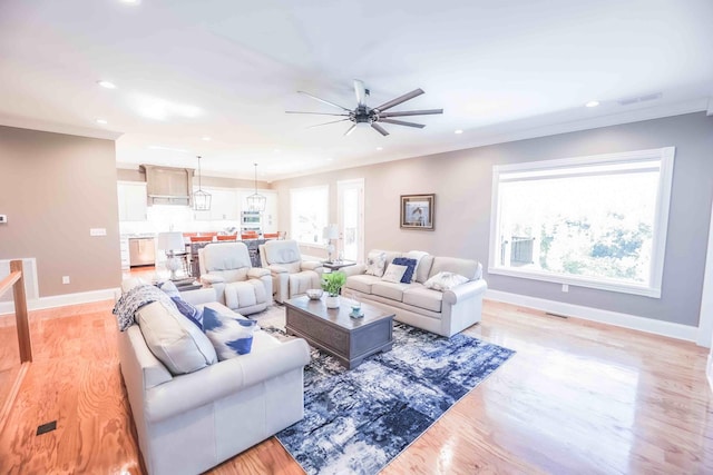 living room with crown molding, recessed lighting, visible vents, and baseboards