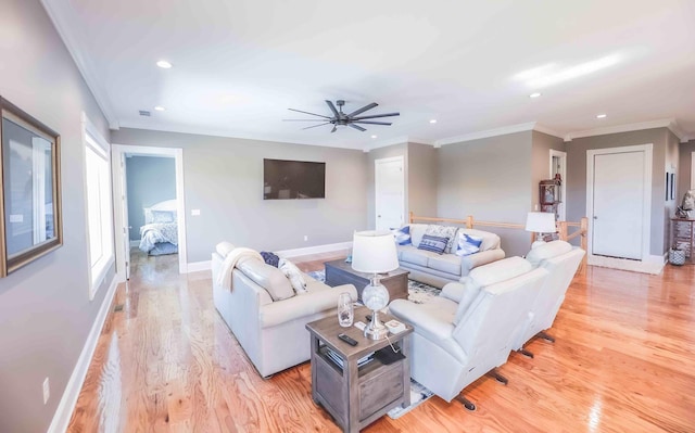 living area featuring baseboards, ornamental molding, recessed lighting, and light wood-style floors