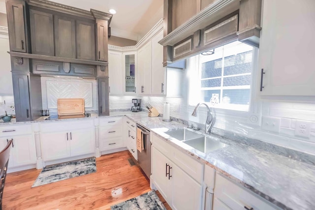 kitchen with glass insert cabinets, white cabinets, a sink, and dishwasher