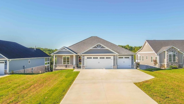 craftsman-style house featuring board and batten siding, a front lawn, driveway, and an attached garage