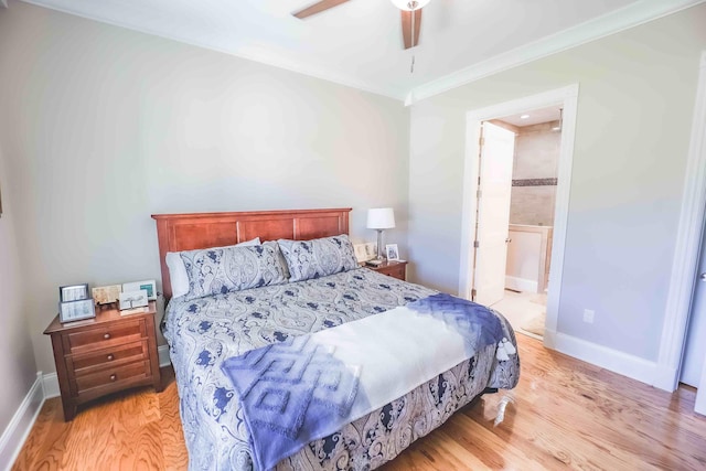 bedroom featuring ensuite bathroom, ornamental molding, light wood-type flooring, and baseboards