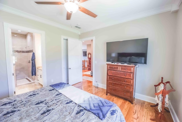 bedroom featuring light wood-style flooring, visible vents, baseboards, ornamental molding, and ensuite bath