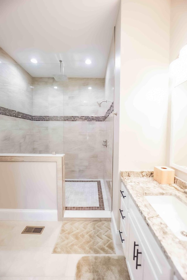 bathroom featuring tile patterned flooring, recessed lighting, visible vents, vanity, and walk in shower