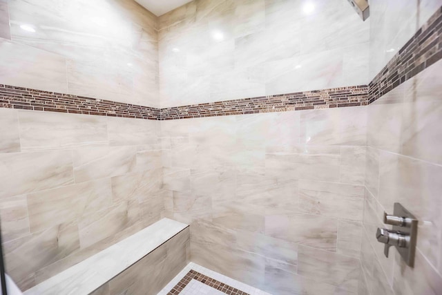 full bathroom with a tile shower