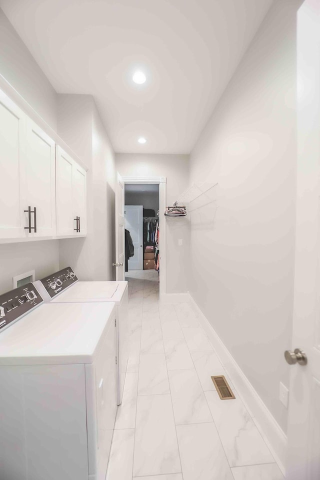 washroom featuring visible vents, baseboards, marble finish floor, independent washer and dryer, and cabinet space