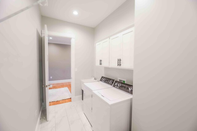 clothes washing area with marble finish floor, cabinet space, baseboards, and separate washer and dryer