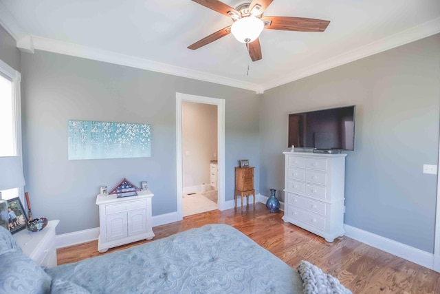 bedroom featuring baseboards, a ceiling fan, ensuite bath, crown molding, and light wood-style floors