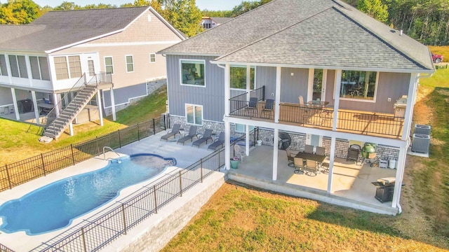 rear view of house featuring a fenced in pool, stairway, roof with shingles, fence, and a patio area