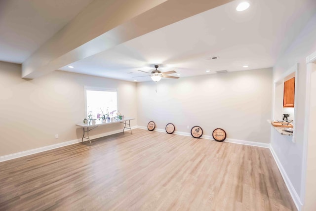 interior space featuring light wood-type flooring and baseboards