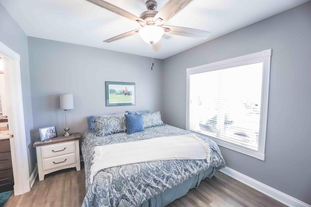 bedroom featuring ceiling fan, dark wood finished floors, and baseboards