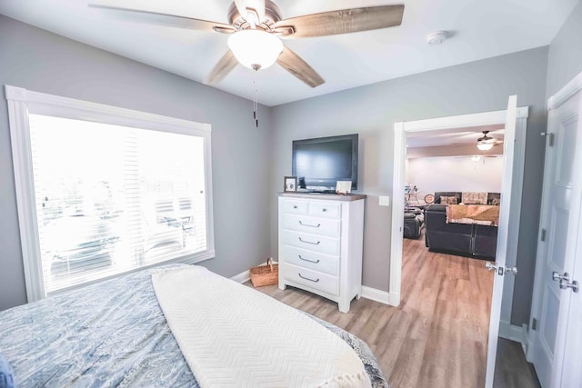 bedroom featuring light wood-type flooring, ceiling fan, and baseboards