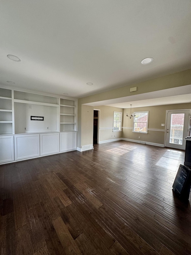 unfurnished living room with dark wood-style floors and baseboards