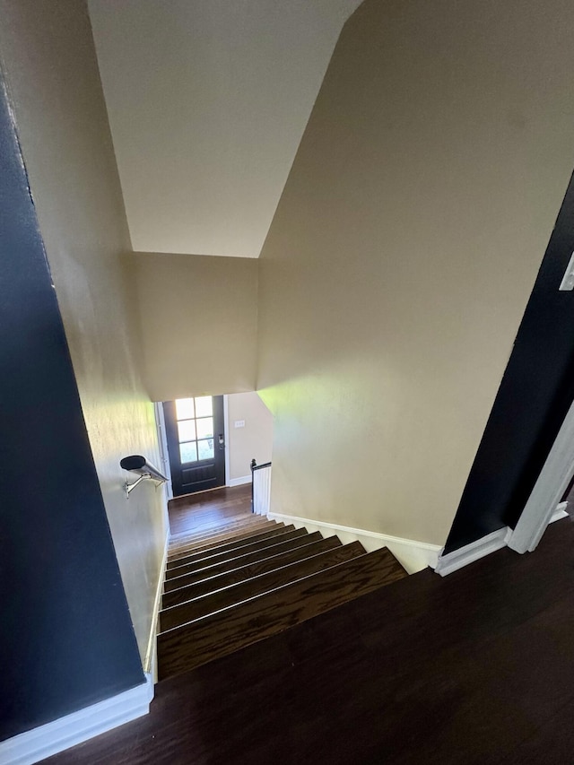 stairway featuring wood finished floors and baseboards
