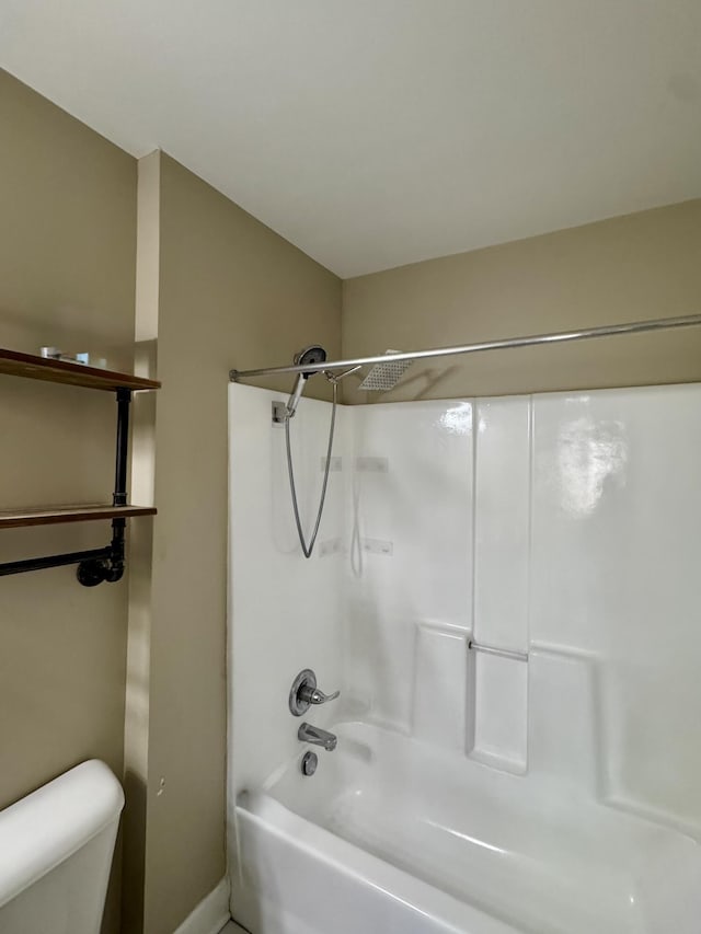 bathroom with shower / bathing tub combination and toilet