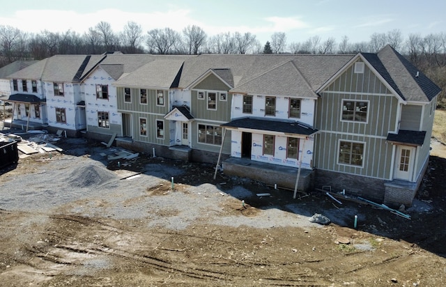 view of front of home featuring a shingled roof and board and batten siding