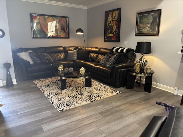 living area with ornamental molding, wood finished floors, and baseboards