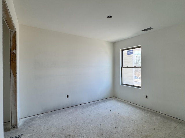 unfurnished room featuring visible vents