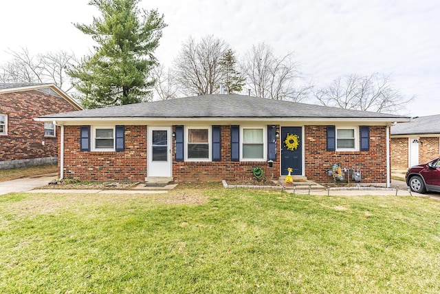 ranch-style home featuring entry steps, brick siding, and a front yard