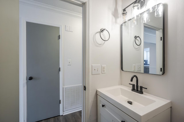 bathroom featuring visible vents, wood finished floors, and vanity