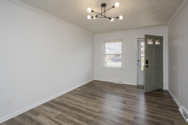 entryway with a chandelier, dark wood finished floors, visible vents, and crown molding