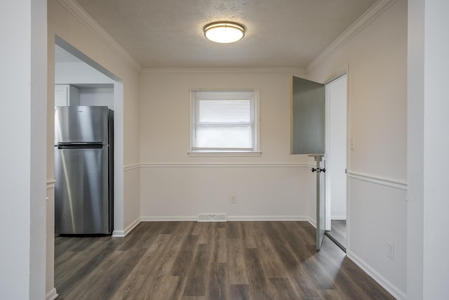 interior space with baseboards, a textured ceiling, visible vents, and dark wood-type flooring