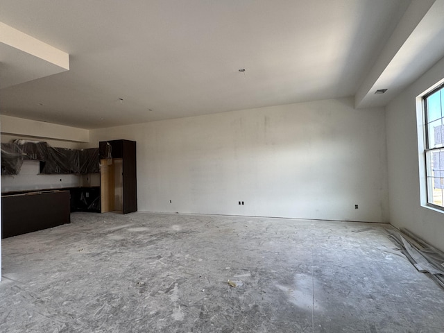 unfurnished living room featuring visible vents