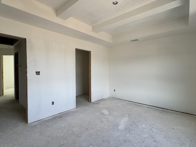 empty room featuring visible vents and beam ceiling