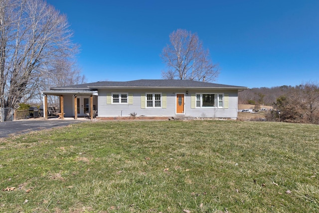 ranch-style house featuring a front yard, aphalt driveway, a carport, and french doors