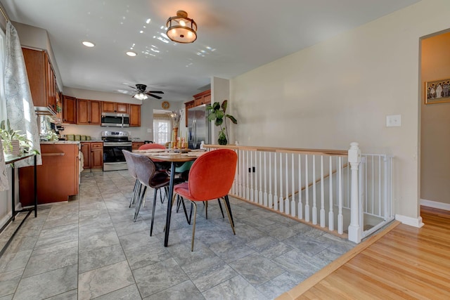 dining area with ceiling fan and baseboards