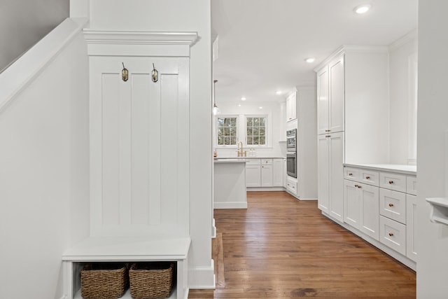 mudroom with a sink, wood finished floors, and recessed lighting