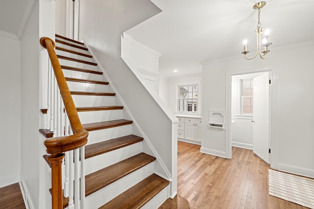 staircase featuring ornamental molding, hardwood / wood-style flooring, and baseboards