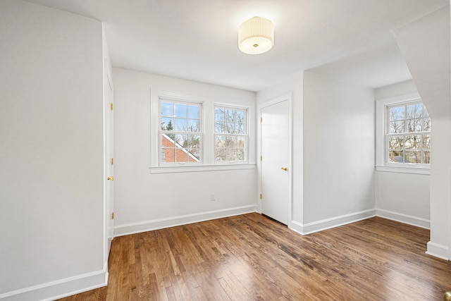 interior space featuring baseboards and wood finished floors