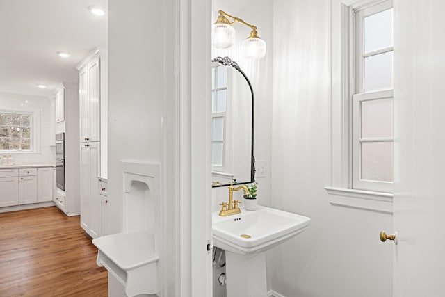 bathroom featuring wood finished floors and recessed lighting